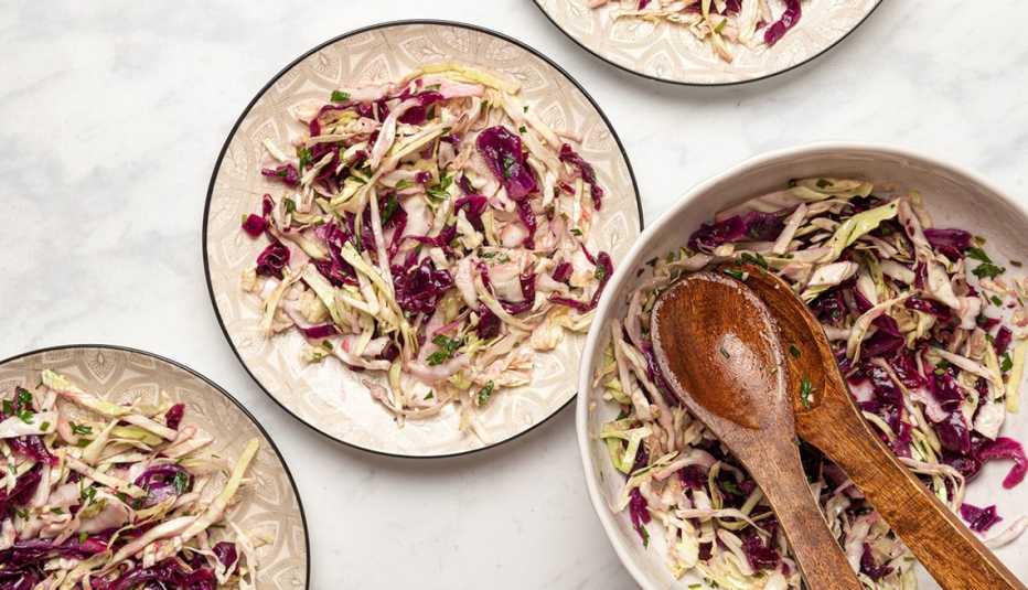 Cabbage salad with lemon-garlic vinaigrette A close-up view of cabbage salad with lemon-garlic vinaigrette on plates