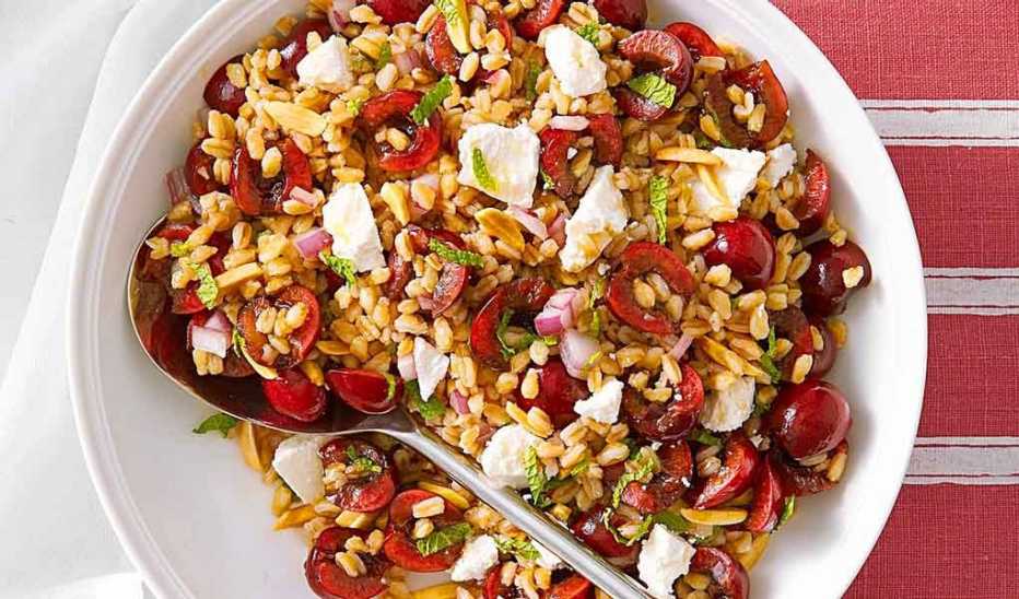 A close-up view of cherry-almond farro salad in a bowl