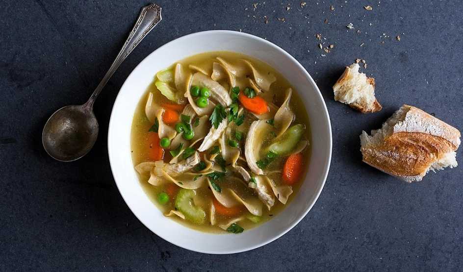 A close-up view of classic chicken soup in a bowl