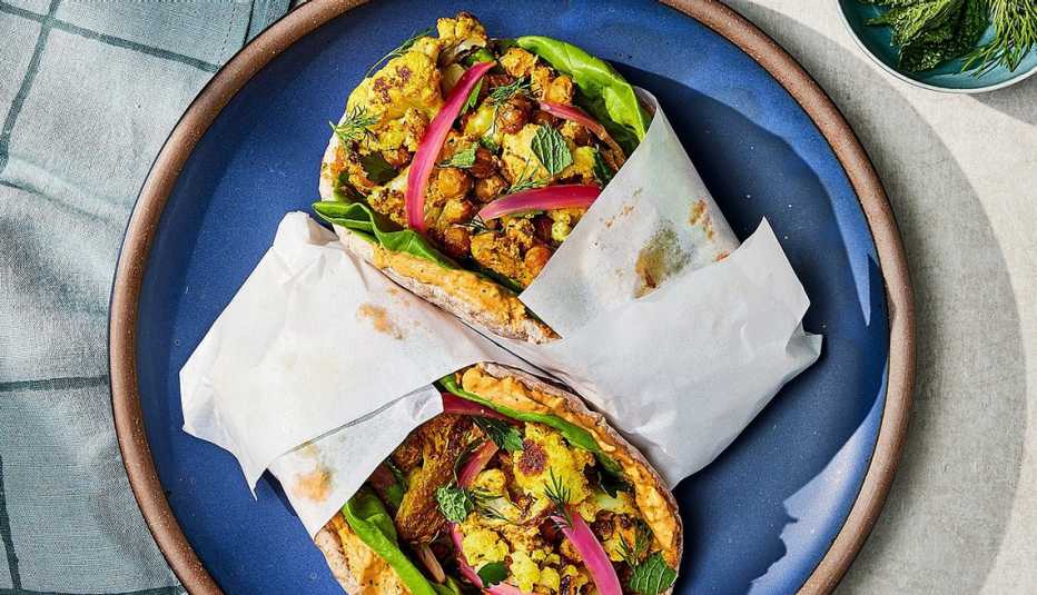 Roasted chickpea and cauliflower pitas with sun-dried tomato sauce A close-up view of roasted chickpea and cauliflower pitas with sun-dried tomato sauce