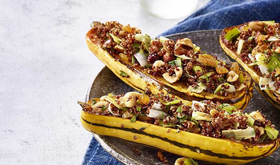 A close-up view of quinoa-stuffed delicata squash on a plate