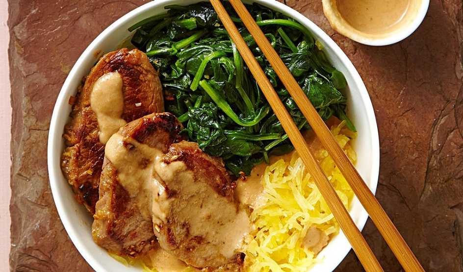 Pork and spaghetti squash noodle bowl A close-up view of pork and spaghetti squash noodle bowl