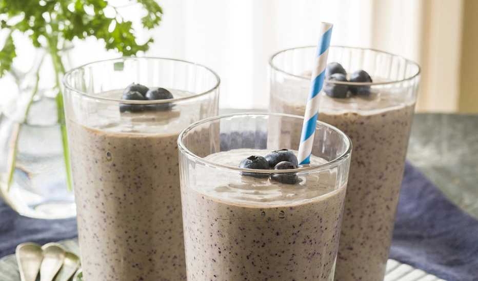 A close-up view of coconut-blueberry green smoothies A close-up view of coconut-blueberry green smoothies