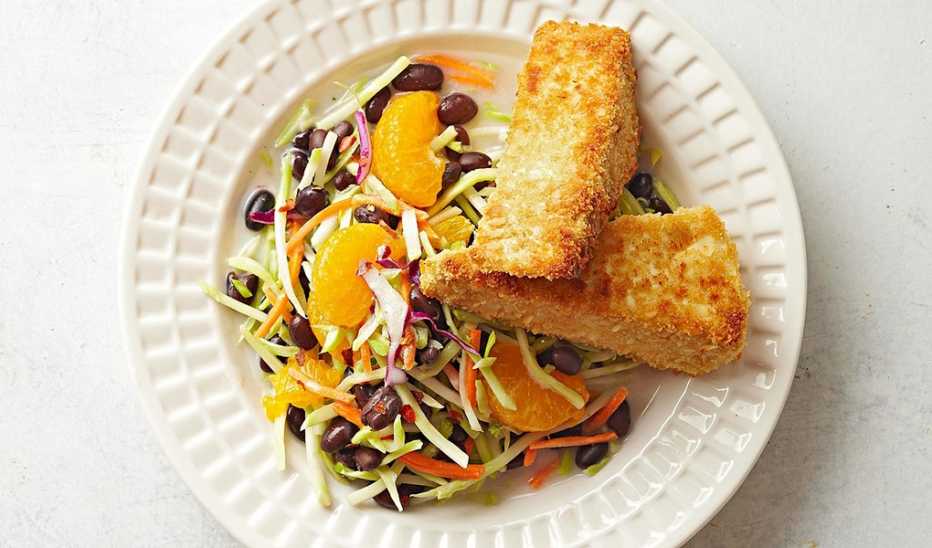 A close-up view of coconut-crusted tofu with black bean slaw on a plate