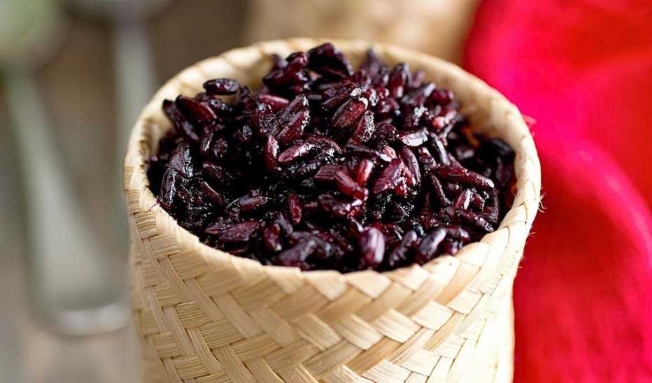 A close-up view of black sticky rice in a bowl