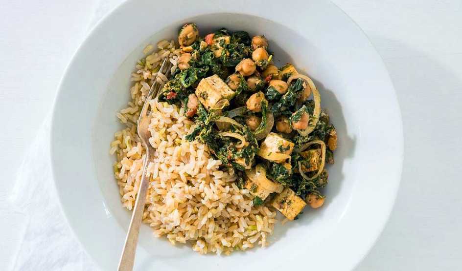 A close-up view of Indian saag with chickpeas on a plate