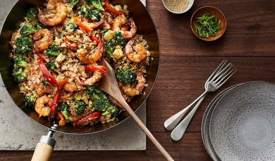 A close-up view of shrimp cauliflower fried rice in a pan