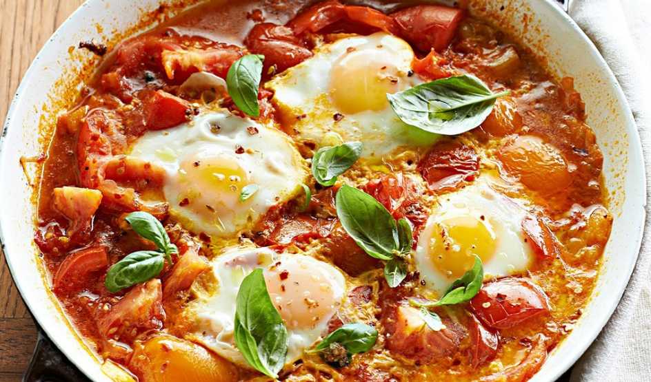 A close-up view of spicy poached eggs in tomato sauce in a bowl
