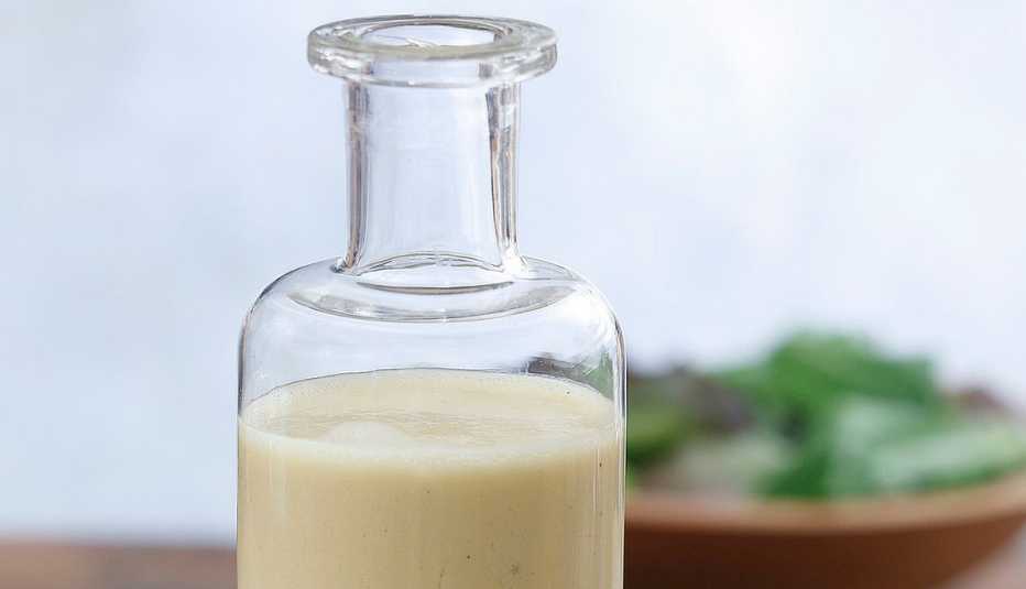 Garlic-dijon vinaigrette A close-up view of a garlic-dijon vinaigrette in a glass bottle