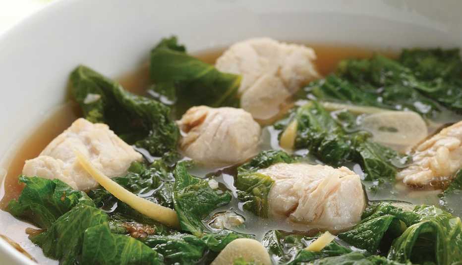 Ginger-chicken stew with greens A close-up view of ginger-chicken stew with greens in a bowl