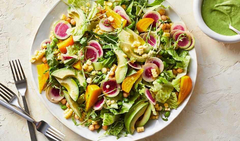 A close-up view of a big beautiful summer salad on a plate