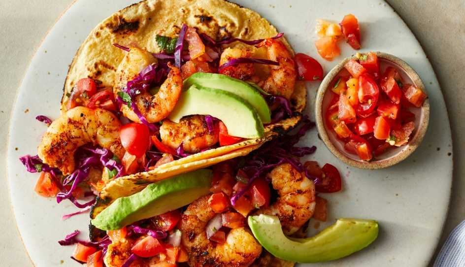 A close-up view of spicy shrimp tacos on a plate