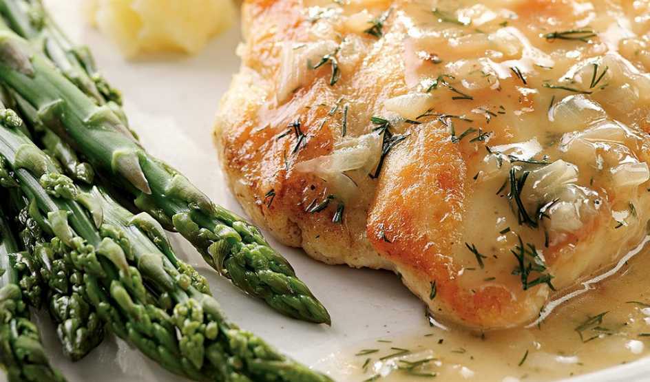 A close-up view of a lemon and dill chicken on a plate