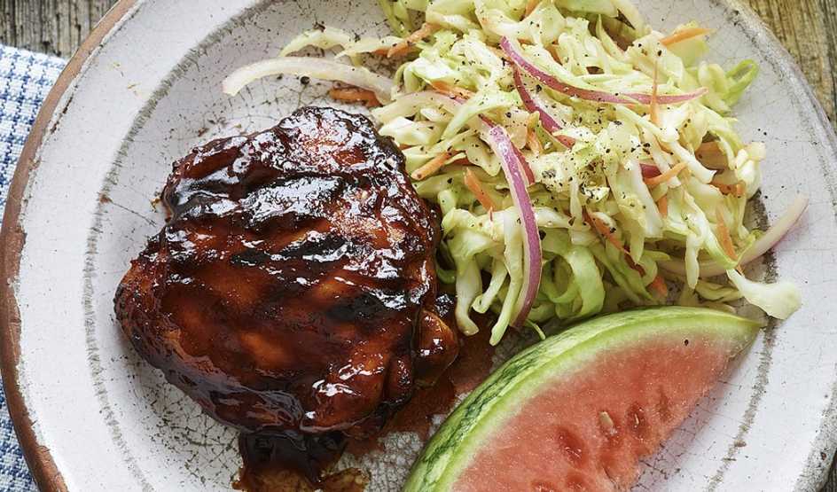 A close-up view of all-American BBQ chicken thighs on a plate