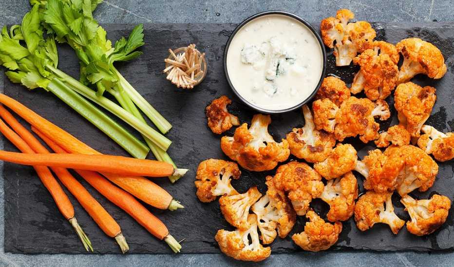 A close-up view of sriracha-buffalo cauliflower bites on a board