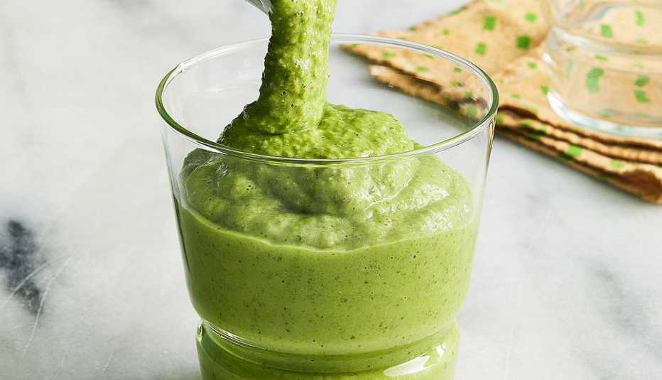 A close-up view of pineapple green smoothie in a glass