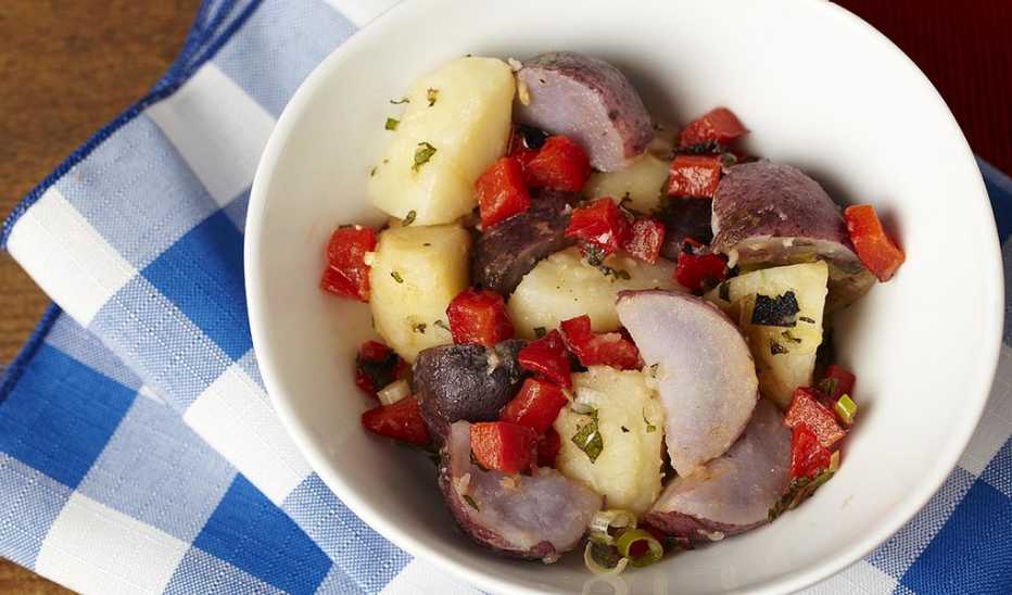 A close-up view of red, white and blue potato salad in a bowl A close-up view of red, white and blue potato salad in a bowl