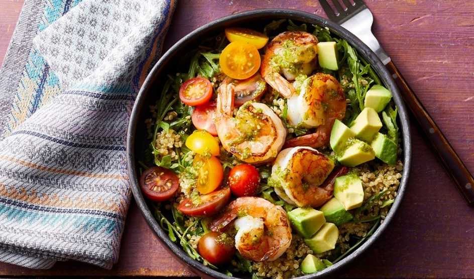 A close-up view of a charred shrimp and pesto Buddha bowl