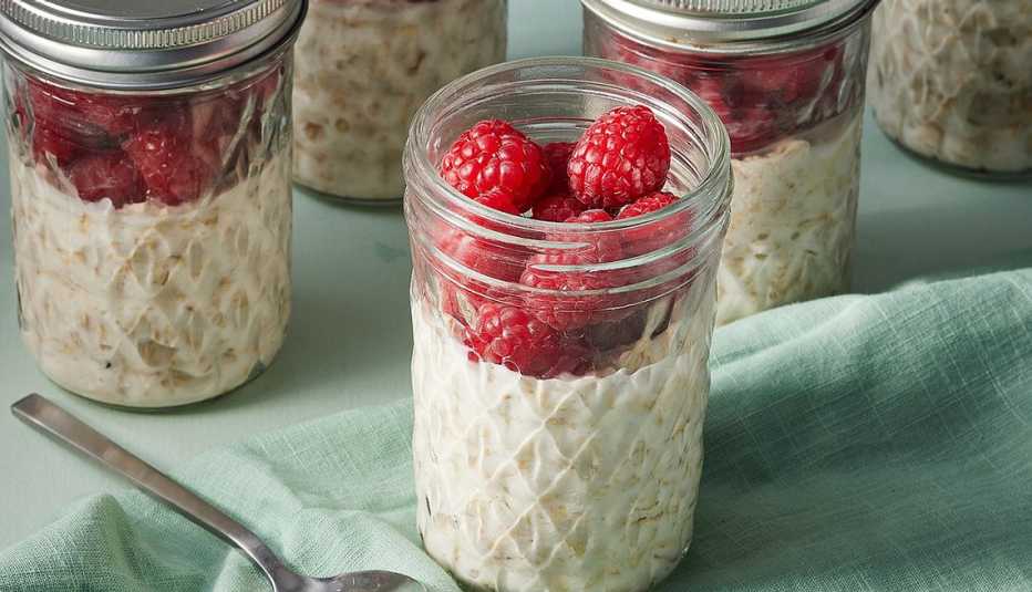 High-fiber raspberry-vanilla overnight oats A close-up view of high-fiber raspberry-vanilla overnight oats in jars