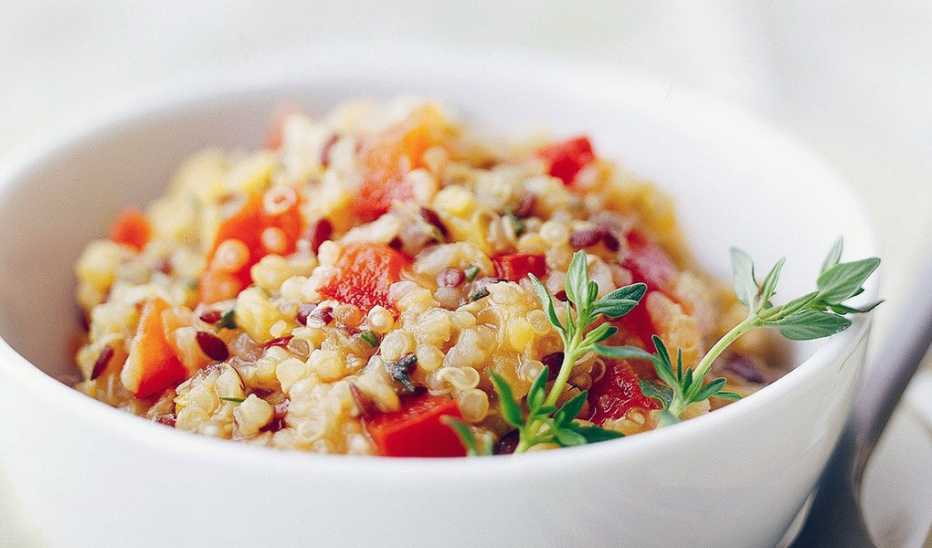 A close-up view of red lentil, quinoa and flaxseed pilaf in a bowl