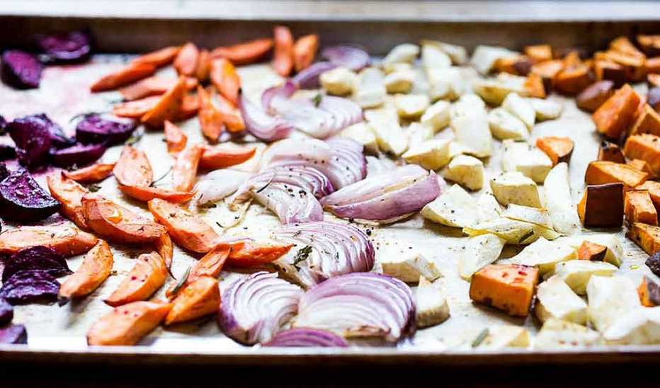 Roasted root vegetables on a sheet pan A close-up view of roasted root vegetables on a sheet pan