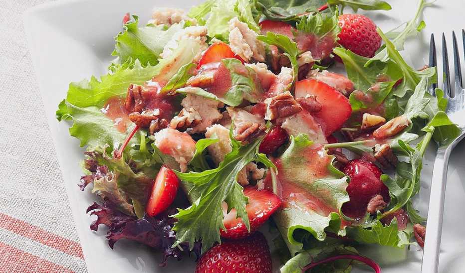 A close-up view of salmon salad with strawberry vinaigrette on a plate A close-up view of salmon salad with strawberry vinaigrette on a plate
