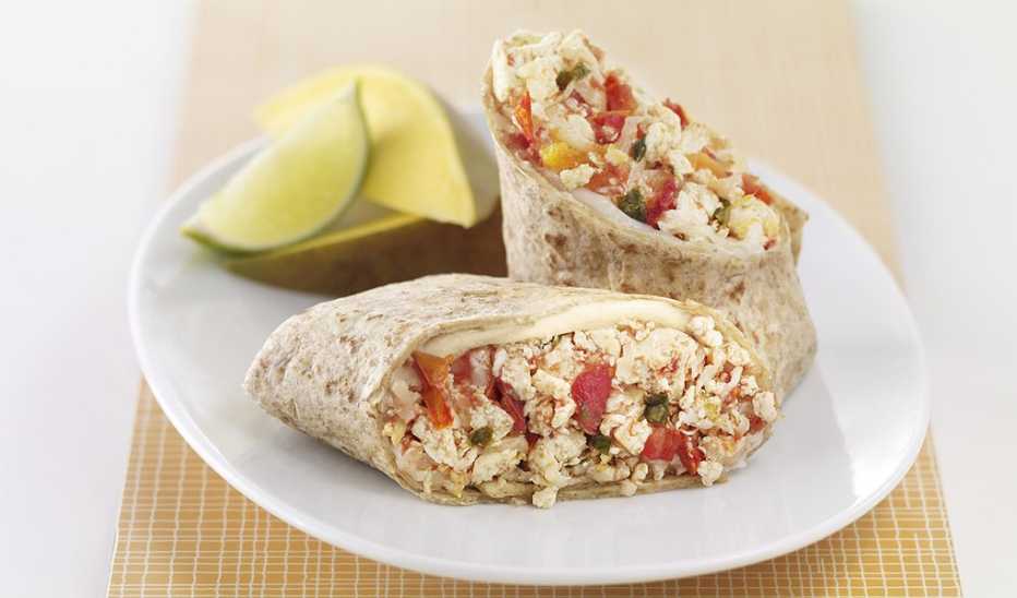 A close-up view of salsa-tofu breakfast burrito on a plate