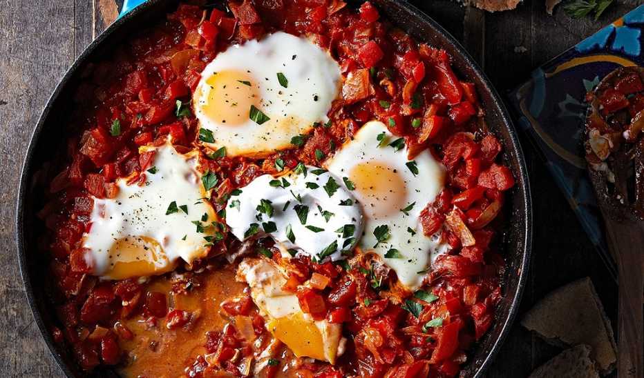 Eggs poached in spicy tomato sauce (shakshuka) A close-up view of eggs poached in spicy tomato sauce (shakshuka) in a pan