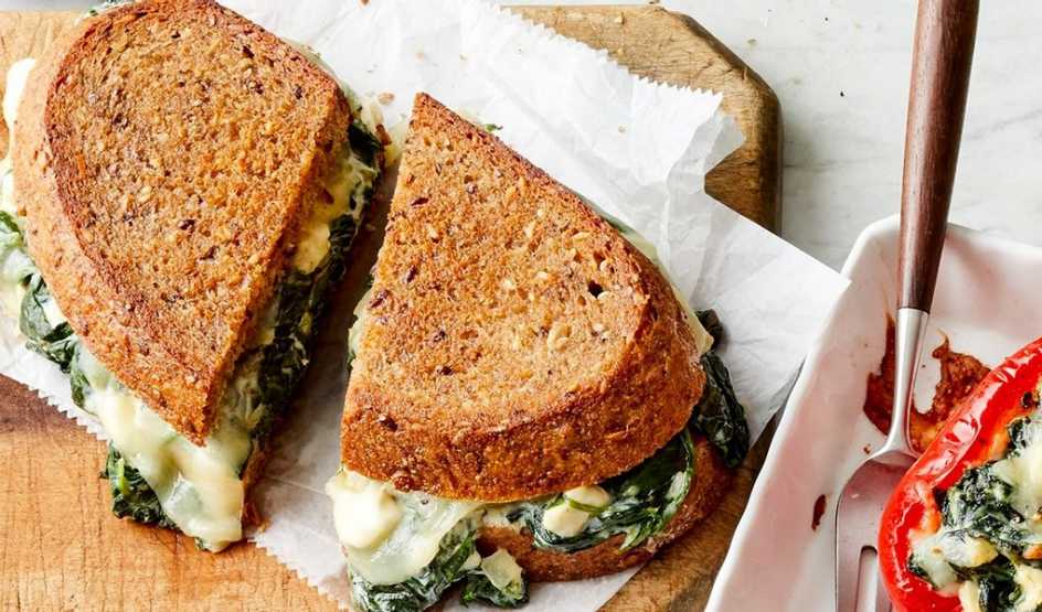 A close-up view of a spanakopita grilled cheese sandwich