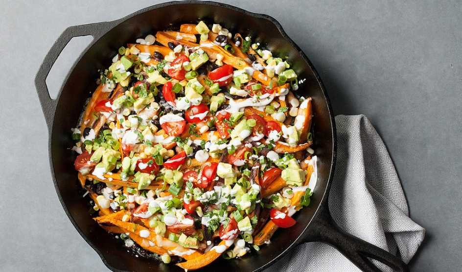 A close-up view of loaded sweet potato nacho fries in a pot