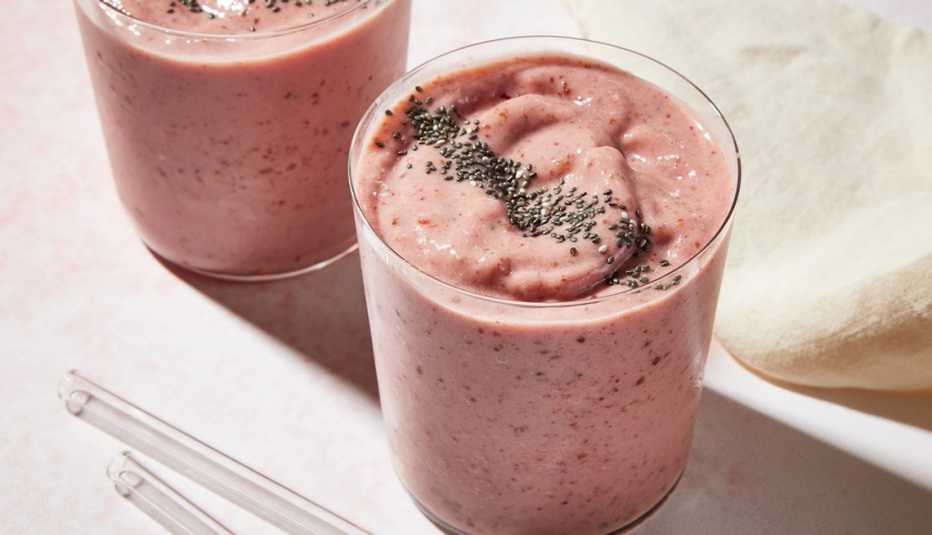 Strawberry-peach chia seed smoothie A close-up view of two strawberry-peach chia seed smoothies