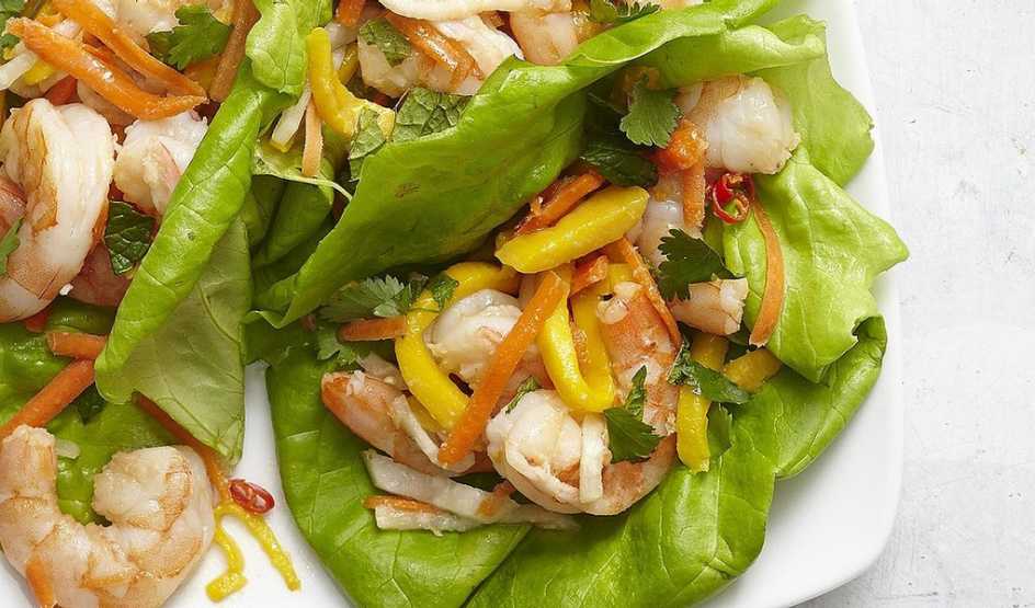A close-up view of Vietnamese shrimp and mango lettuce wraps on a plate A close-up view of Vietnamese shrimp and mango lettuce wraps on a plate