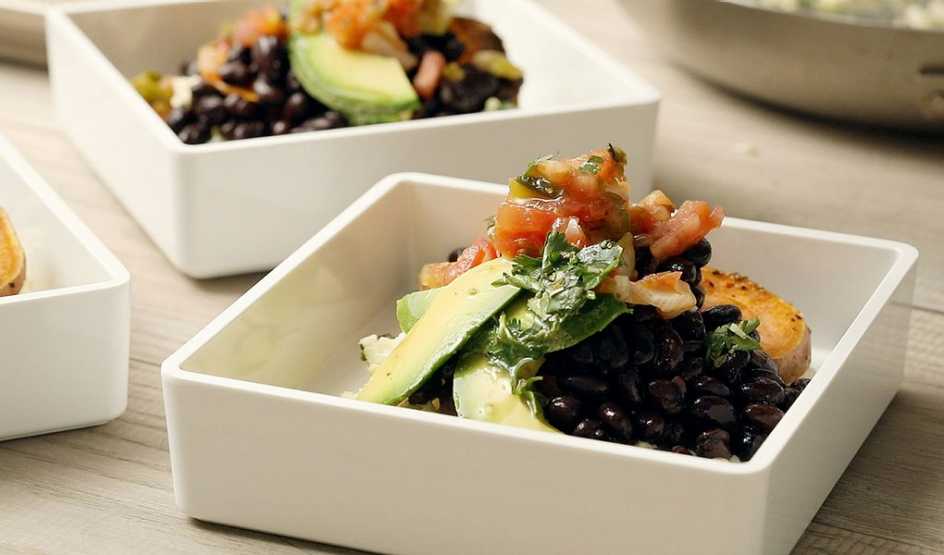 A close-up view of Cuban cauliflower rice bowls in bowls
