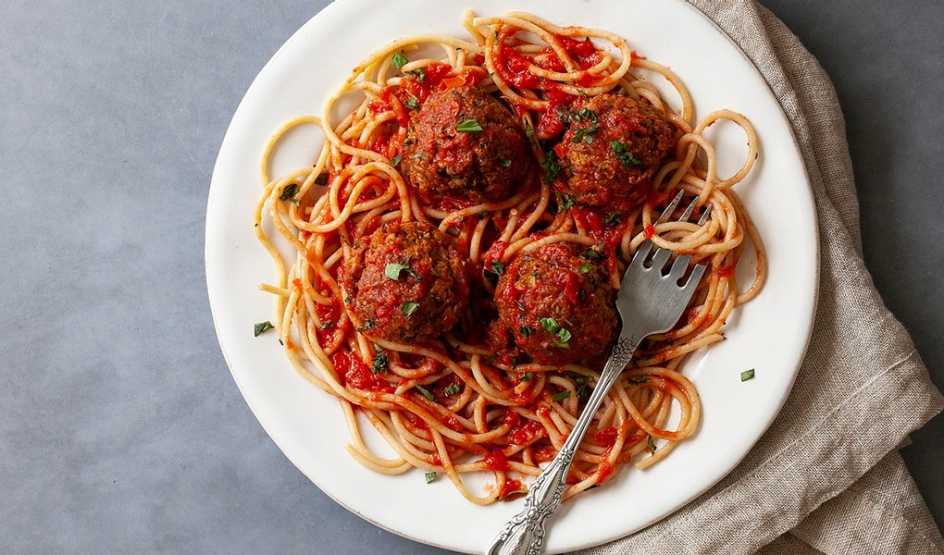 A close-up view of saucy vegetarian meatballs on a plate
