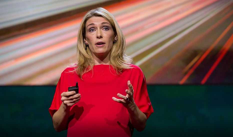 A woman, Abigail Marsh, speaking on stage at a TED event