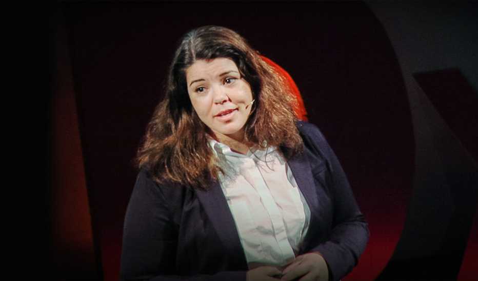 A woman, Celeste Headlee. speaking on stage at a TED event