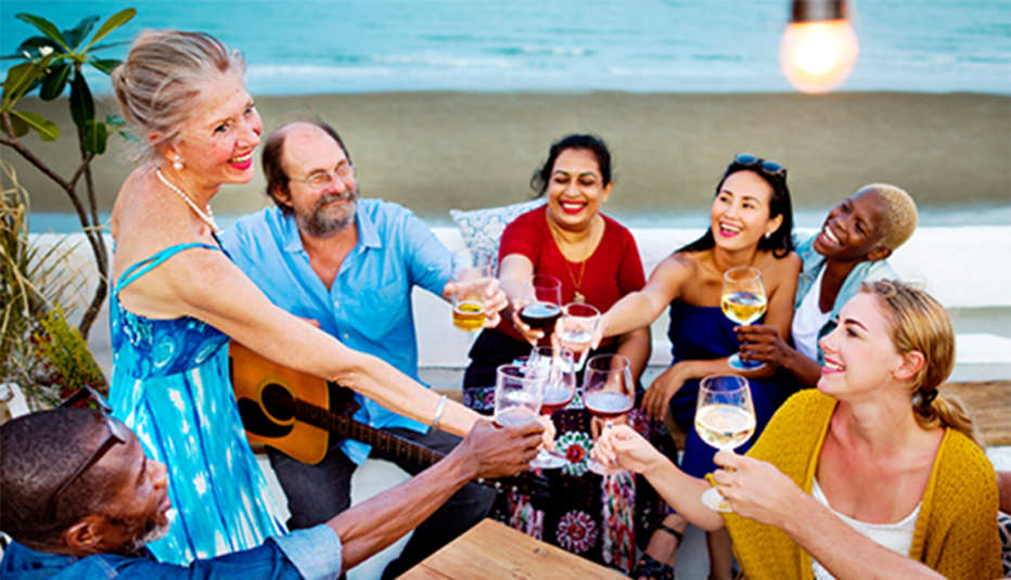 A group of people drinking together on the beach