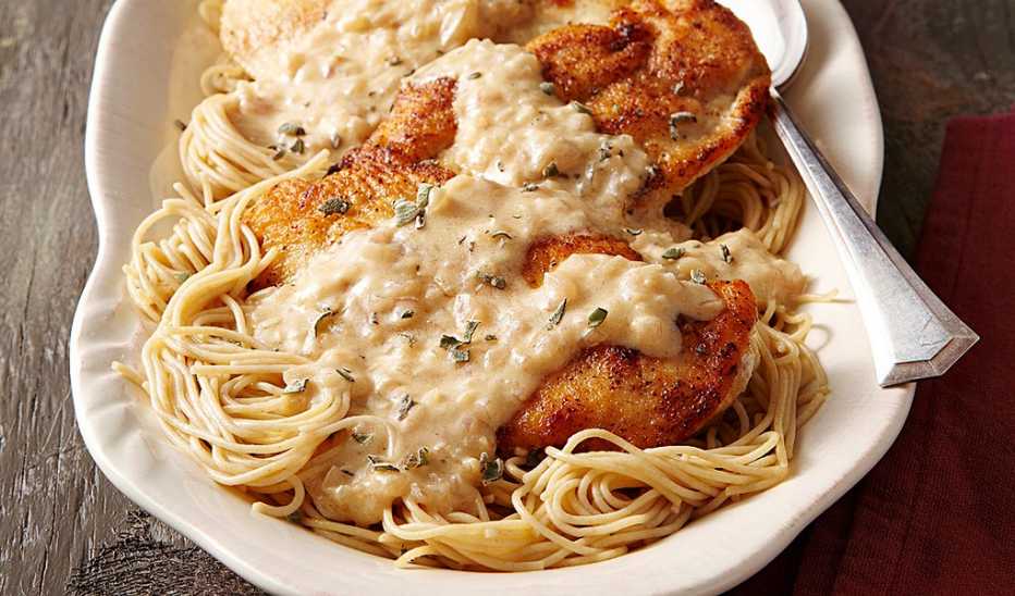 A close-up view of creamy mustard chicken on a plate