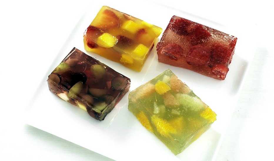 A close-up view of sparkling raspberry jello jiggers