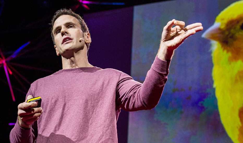 A man, Read Montague, speaking on stage at a TED event