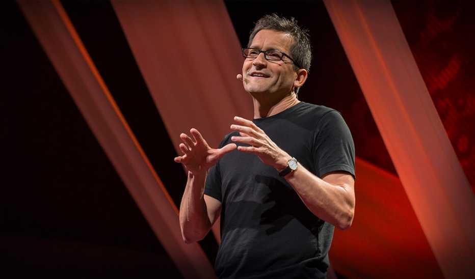 A man, Jim Hemerling, speaking on stage at TED@BCG