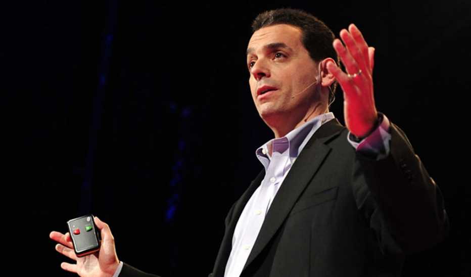 A man, Dan Pink, speaks on stage at TED