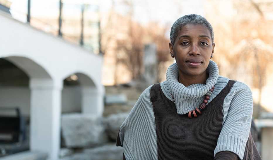 A woman sitting outside while looking contemplative