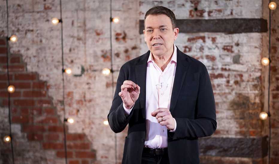 A man, Bruce Feiler, speaking on stage at a TED event