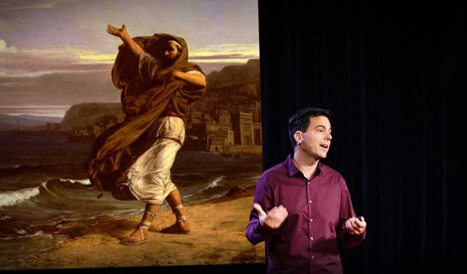 A man, Eduardo Briceño, speaking on stage at a TED event