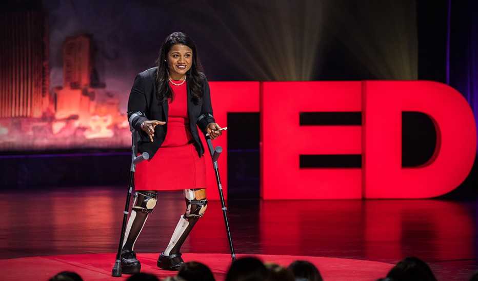 A woman, Minda Dentler, speaking on stage at TEDWomen 2017