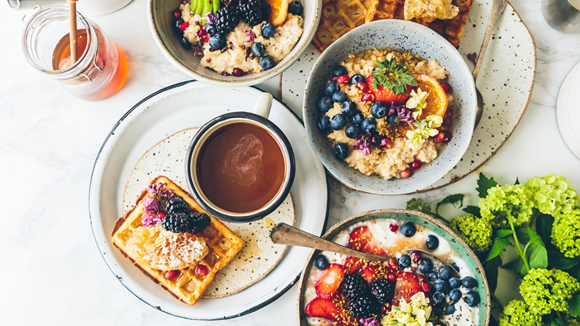 An overhead view of an assortment of healthy food on a white background