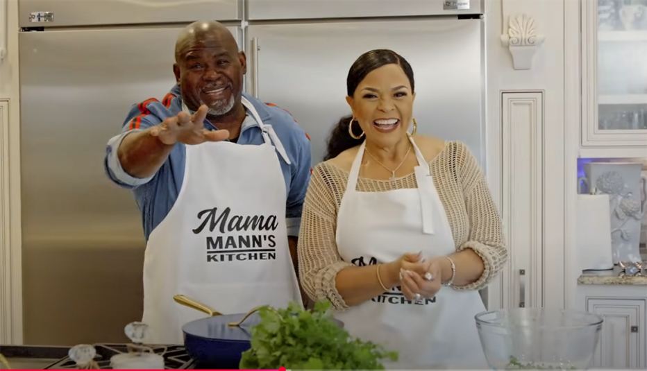 Mama Mann and her husband, David Mann, smiling together in the kitchen