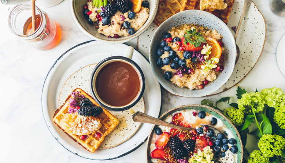 An overhead view of an assortment of healthy food on a white background