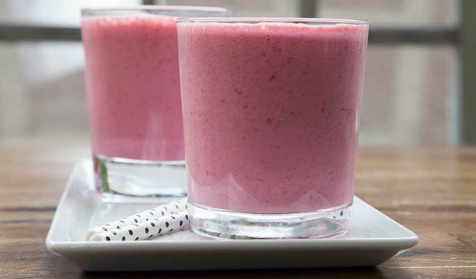 A close-up view of strawberry-almond smoothie in two glasses